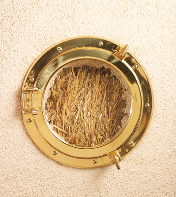A porthole serves as the “truth window,” affording visitors the opportunity to see what really lies behind the interior walls.